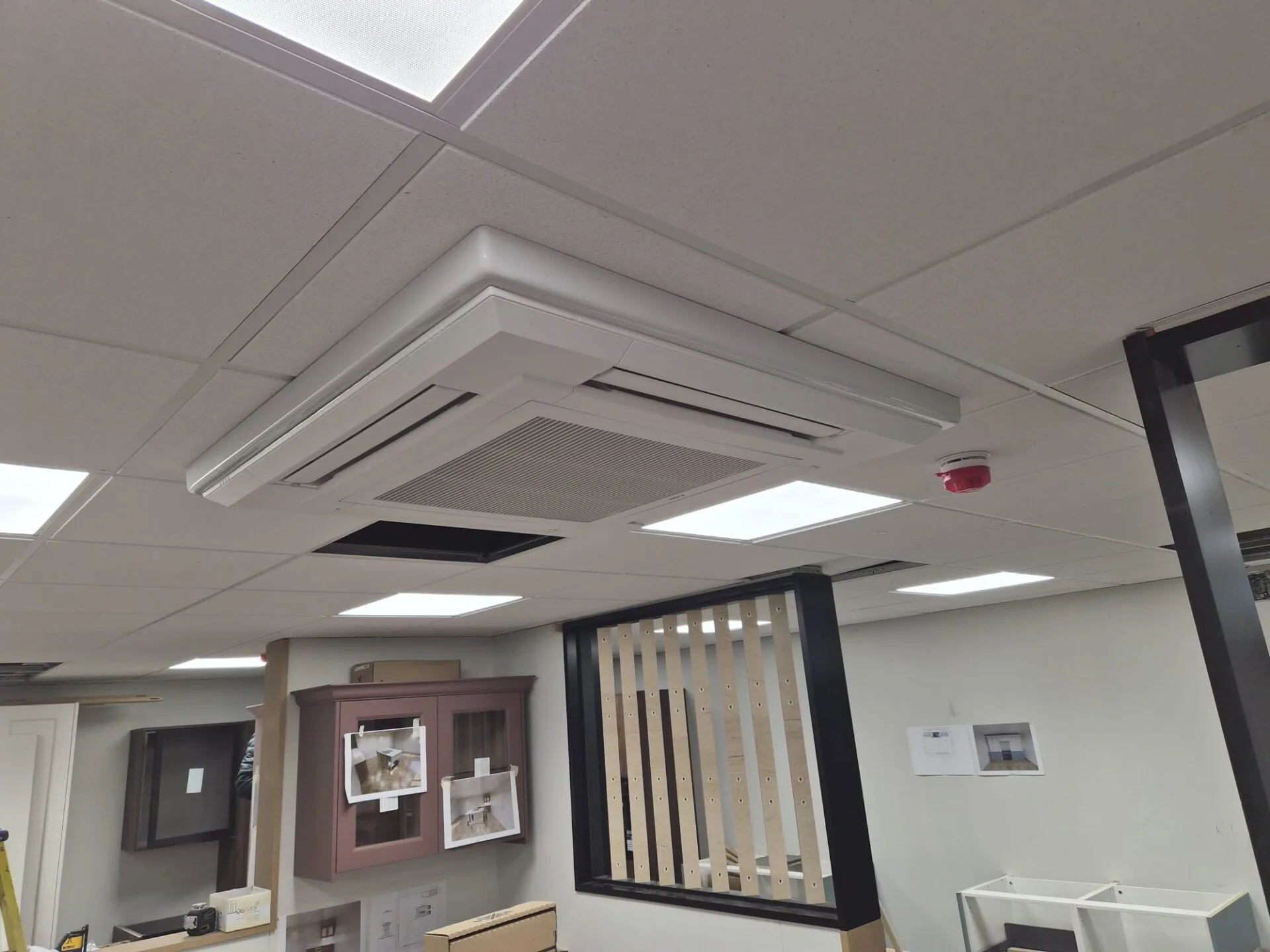 Suspended ceiling cassette air conditioning unit installed during a commercial fit-out