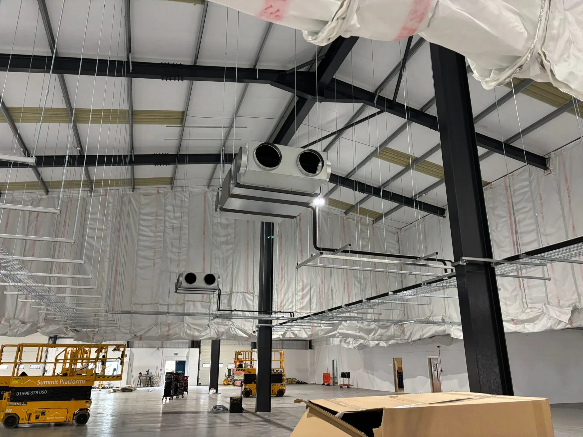 Commercial warehouse interior with ceiling-mounted air handling units